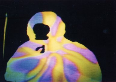 Frame from Ajit Mookerji Speaks by Joeseph El Khouri at Bush Video. Colourised feedback in keyed image of the speaker. (1974)